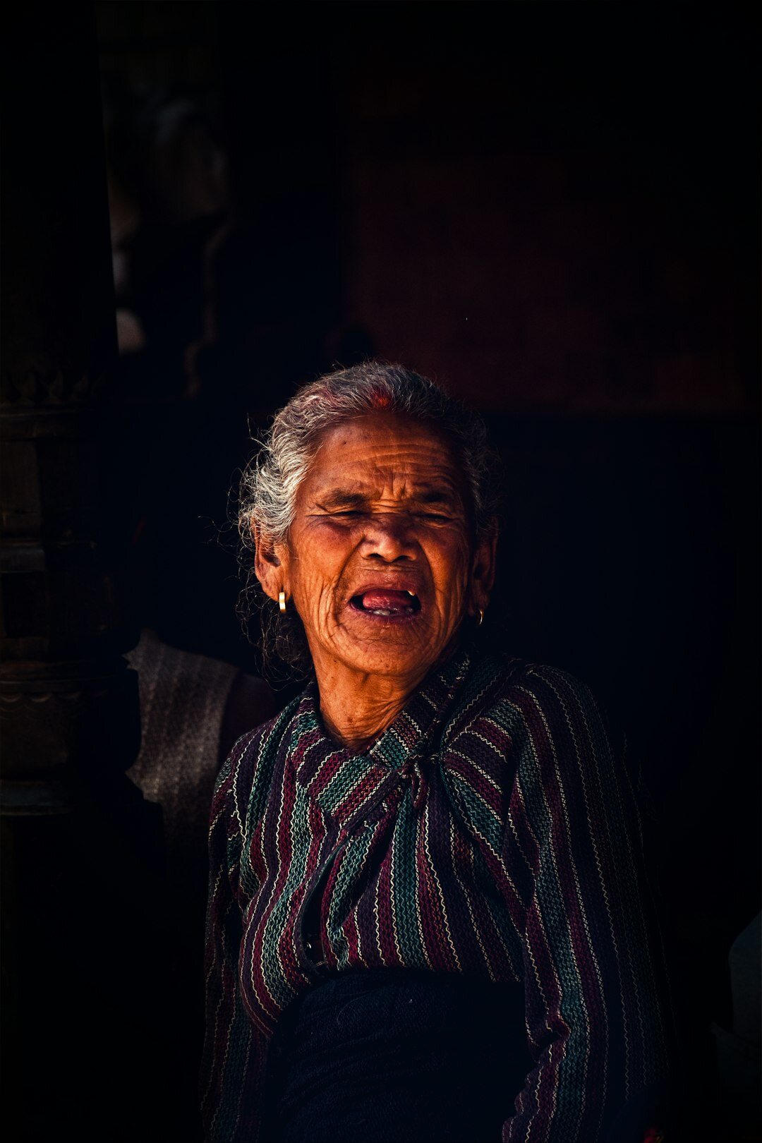 Portrait of an elderly Danish woman smiling in her garden