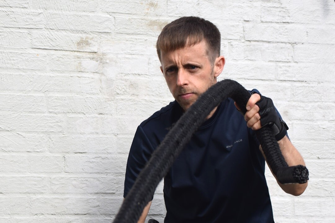 Portrait of a Danish male photojournalist with a camera strap