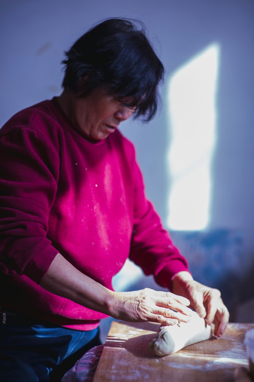 elderly woman baking bread